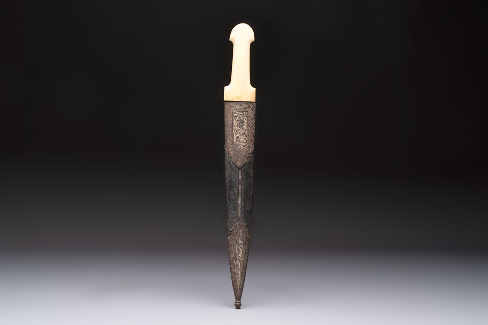 A Caucasian gilt Damascus steel 'Khinjal' with a whale bone hilt and a leather and damascened steel scabbard, 19th C.