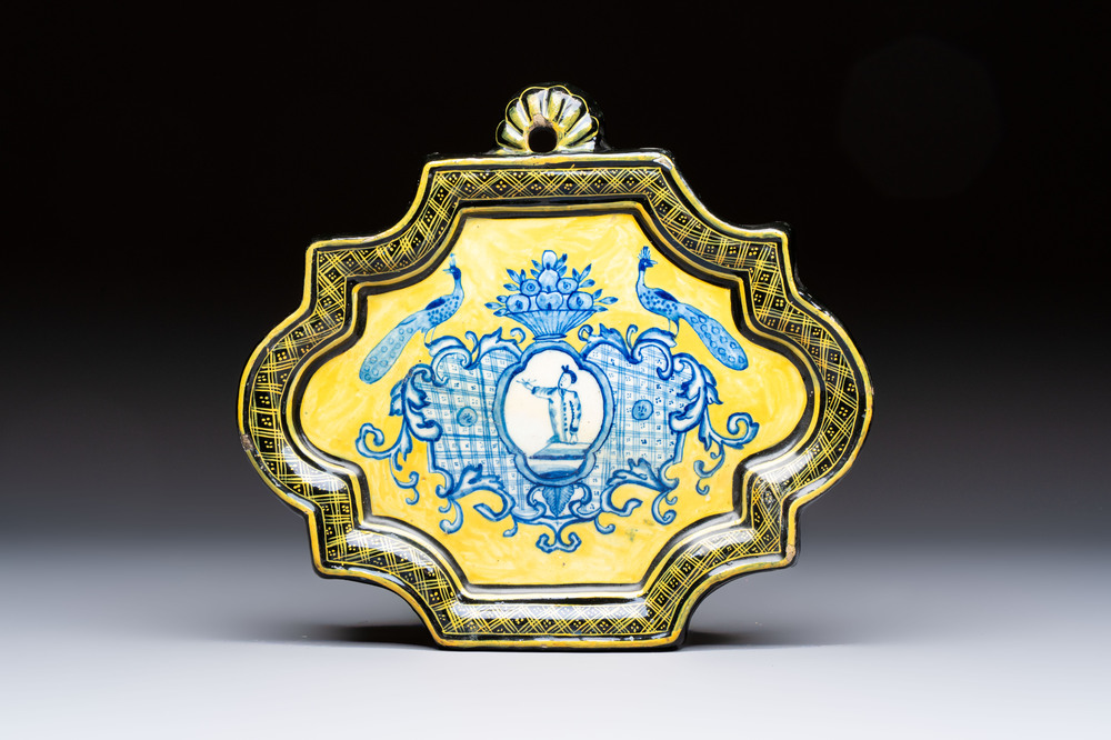 A rare blue and white yellow-ground Dutch Delft plaque with a black border, 18th C.
