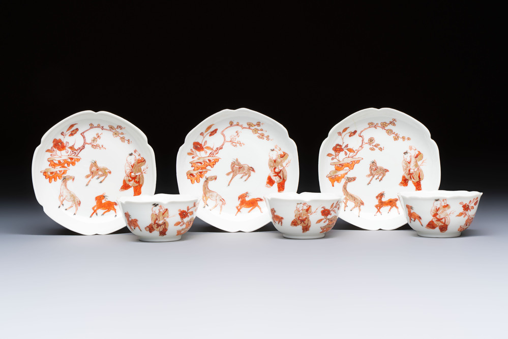 Three fine Chinese eggshell iron-red and gilt-decorated 'Boy and Goats' cups and saucers, Yongzheng