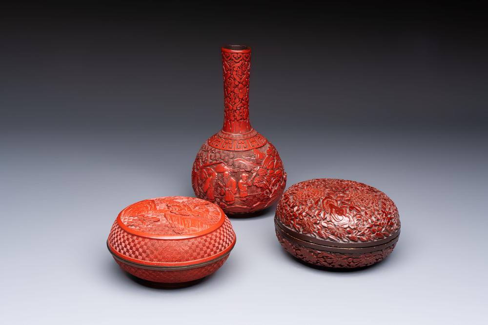Two Chinese cinnabar lacquer covered boxes and a bottle vase, 19th C.