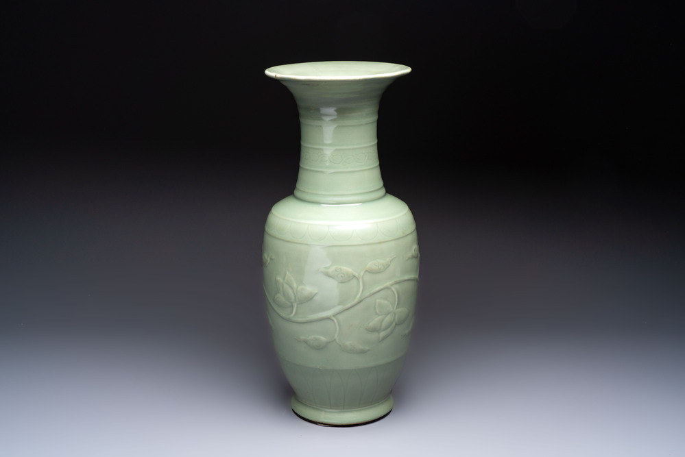 A Chinese celadon-glazed vase with relief lotus scroll design, 18th C.