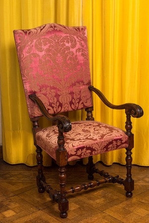 A wooden armchair with red velvet lining, 18th C.