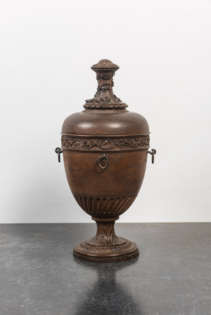 A patinated carved wooden urn and cover, probably France, 19th C.