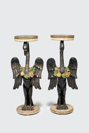 A pair of large polychromed wooden plant stands in the shape of swans with floral wreaths, ca. 1900