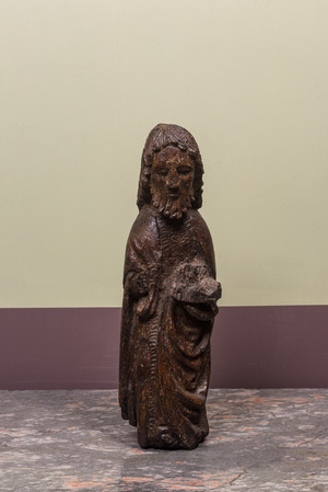 A Spanish walnut figure of John the Baptist, mid 15th C.