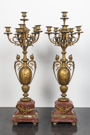 A pair of large gilt brass candelabra on red marble bases, 19th C.