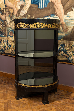 A gilt copper-mounted ebonised demi-lune bar cabinet with mirror back, 19th C.