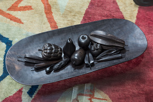 An oval wengé wooden tray with thirteen carved fruits, Africa, 20th C.