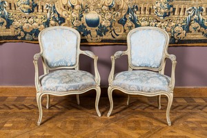 A pair of French Louis XV-style patinated wooden armchairs, 20th C.