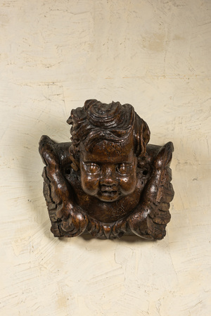 A large carved wood winged putto head, 17th C.
