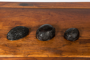 Three carved coconut pendants, French colonies, 19th C.
