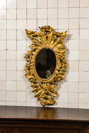 A richly carved gilt wooden Rococo mirror, 18th C.