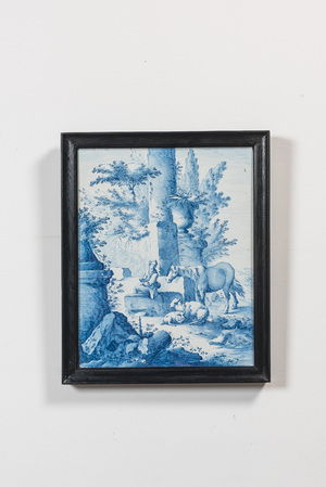 A fine blue and white 'pastoral subject' stove tile mounted as a plaque, France, 18/19th C.