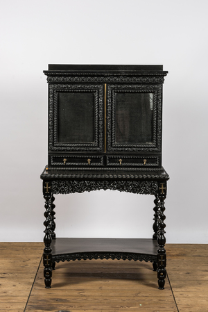 An ebonised wooden cabinet on stand with mirrored doors, 19th C.