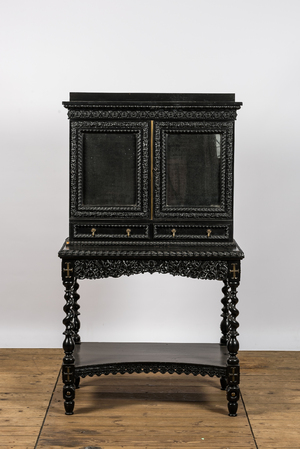 An ebonised wooden cabinet on stand with mirrored doors, 19th C.