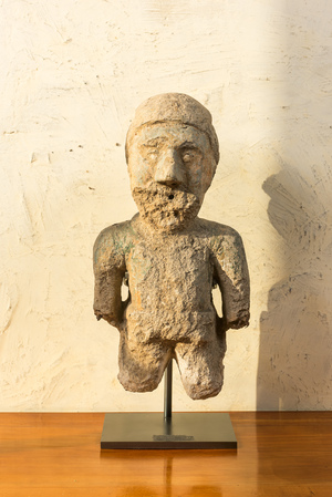 A worn patinated stone fountain ornament in the shape of a lumberjack, 19th C.