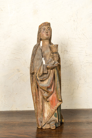 A German polychromed basswooden Saint Odilia holding a chalice, Middle-Rhein area, early 16th C.