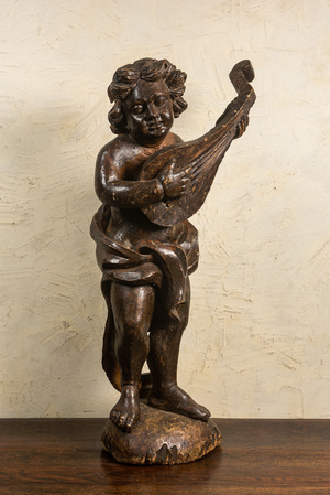 A large patinated wooden putto playing the lute, 18th C.