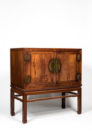 A Chinese hardwooden brass mounted two-door cabinet on foot, 20th C.