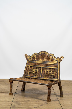 A colonial-inspired brass mounted wooden bench, 20th C.