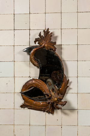 A moon-shaped mirror in a basswooden 'dragon' frame in the style of Viardot, 19/20th C.