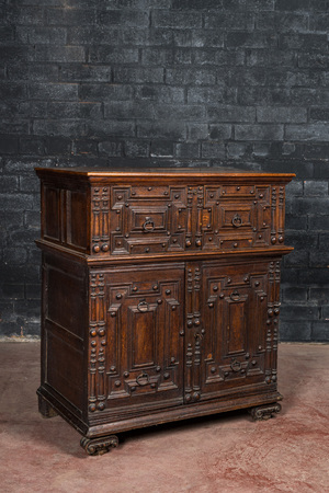 An English Jacobean style carved oak cabinet with two doors beneath a drawer, 17th C. and later