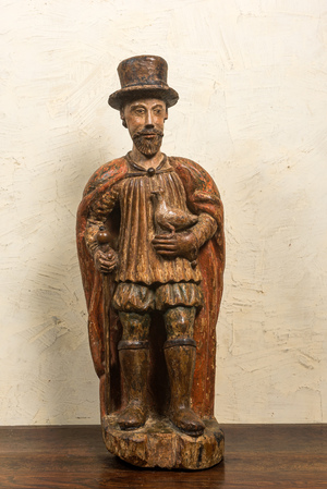 A Spanish polychrome walnut figure of a nobleman with a dove, 16/17th C.