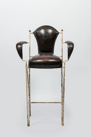 A decorative bar chair in leather and patinated metal, 20th C.