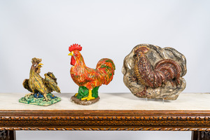 Two polychrome roosters in terracotta and composite stone and a wooden relief, 19/20th C.