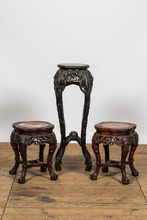 Three Chinese carved wooden stands with marble top, 19/20th C.