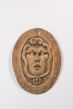 A large oval carved wooden 'Medusa' relief, 19th C.