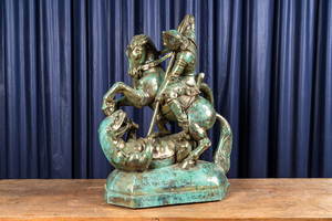 A large faux bronze-patinated pottery group with Saint George beating the dragon, mid 20th C.