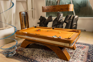 A burl wood veneered billiard table with accompanying lighting and cue holder, 20th C.