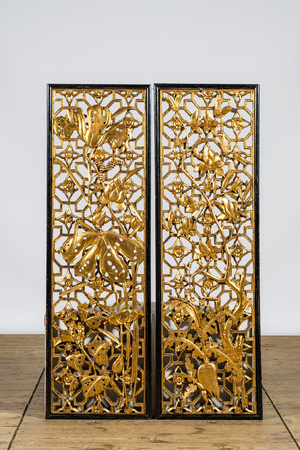 A pair of Chinese openworked and gilt wooden panels with floral design, 19/20th C