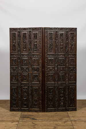 A richly sculpted two-panel French oak room divider with Japonism embroidery, France, 19th C.