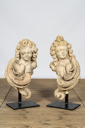 A pair of French limestone angel busts on a metal base, 18th C.