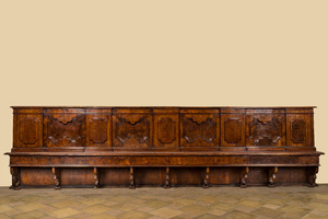 An impressive large Italian walnut and root wood veneer bench with geometric decoration of molded panels, 17th C.