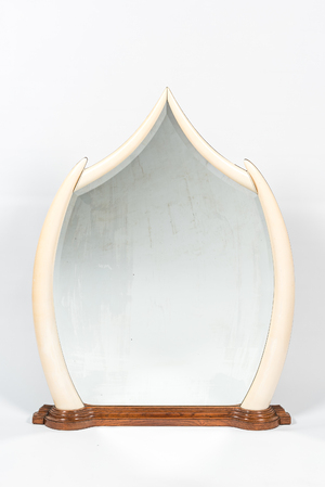 A large mirror set in faux ivory tusks, 20th C.