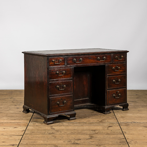 A small wooden nine drawer-desk, 19th C.