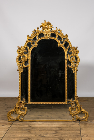A French finely carved gilt wooden Louis XV-style rocaille mirror, 19th C.