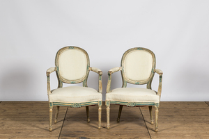 A pair of French white- and green-painted wooden armchairs, 19th C.