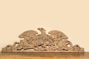 A large leached oak relief depicting an eagle slaying a serpent and two angels, 18th C.