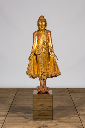 A tall inlaid gilt wooden figure of a standing Buddha, Thailand, 20th C.