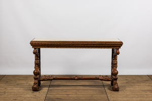 A richly carved wooden wall console with marble top, 19th C.