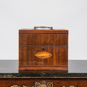 An English mahogany liqueur cellar with six partly gilt carafes, 19th C.