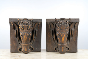 A pair of patinated wooden wall consoles with a horse's head, 20th C.