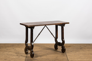 A Spanish walnut table with wrought iron connection, 19th C.