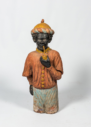 Een Franse polychrome terracotta schouw in de vorm van een pijprokende Moor, ca. 1900