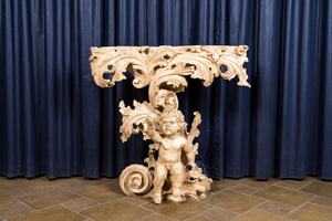 An Italian patinated wooden console with a putto below foliage, 19th C.