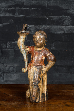 A wrought iron candlestick-mounted polychromed wooden figure of a lady holding a torch, 17th C.